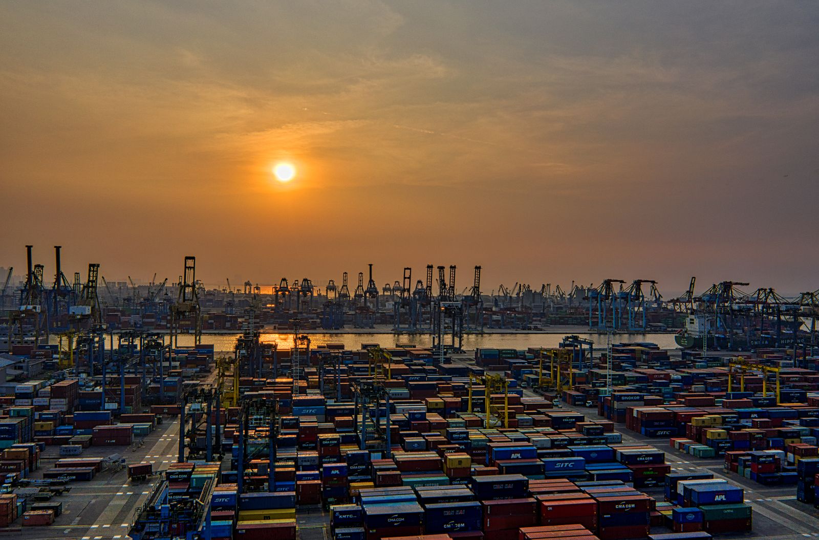Container port cranes loading shipping containers, representing elevator freight from China to Dubai