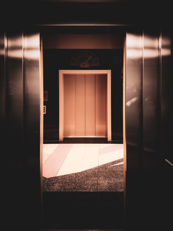 Modern MRL elevator interior with warm lighting in a contemporary building